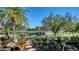 Landscaped yard with stone pathway, tropical plants and water views at 3598 Fair Oaks Ln, Longboat Key, FL 34228