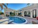 Inviting kidney-shaped pool with brick patio and seating area at 3598 Fair Oaks Ln, Longboat Key, FL 34228