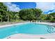 Inviting community pool with lounge chairs at 3598 Fair Oaks Ln, Longboat Key, FL 34228