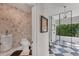 Stylish bathroom featuring a urinal, toilet, and a walk-in shower with a glass enclosure at 3709 Beneva Oaks Way, Sarasota, FL 34238