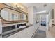 Elegant bathroom with a long, dark countertop, custom cabinets, and views of the Primary bedroom and shower at 3709 Beneva Oaks Way, Sarasota, FL 34238