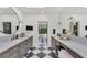 Elegant bathroom with double vanities, marble countertops, and a black and white checkered floor at 3709 Beneva Oaks Way, Sarasota, FL 34238