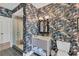 Stylish bathroom featuring patterned wallpaper, modern vanity, and glass-enclosed shower, creating a unique and inviting space at 3709 Beneva Oaks Way, Sarasota, FL 34238