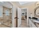 Modern bathroom with a walk-in shower, stylish tile and en-suite access to bedroom at 3709 Beneva Oaks Way, Sarasota, FL 34238