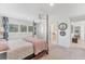 Bright bedroom with four-poster bed and access to bathroom at 3709 Beneva Oaks Way, Sarasota, FL 34238