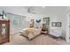 Cozy bedroom featuring a tufted headboard, mirrored accents, and soft, inviting decor at 3709 Beneva Oaks Way, Sarasota, FL 34238