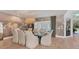 Bright dining room featuring a beautiful wallcovering, hardwood floors, and a large chandelier at 3709 Beneva Oaks Way, Sarasota, FL 34238