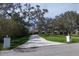 Long driveway leading to an elegant home, lined with lush greenery and mature trees for ultimate privacy at 3709 Beneva Oaks Way, Sarasota, FL 34238