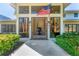 Elegant entryway with large windows and a view of the lush landscaping at 3709 Beneva Oaks Way, Sarasota, FL 34238