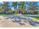 Beautiful home exterior with palm trees and a circular driveway at 3709 Beneva Oaks Way, Sarasota, FL 34238