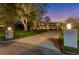 Grand entrance to a beautiful home with landscape lighting at night at 3709 Beneva Oaks Way, Sarasota, FL 34238