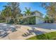 Home's exterior showcasing a side view and lush landscaping at 3709 Beneva Oaks Way, Sarasota, FL 34238