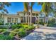 Home's exterior showcasing lush landscaping and a double entry door at 3709 Beneva Oaks Way, Sarasota, FL 34238