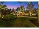 Home exterior at dusk, showcasing landscaping and elegant design at 3709 Beneva Oaks Way, Sarasota, FL 34238