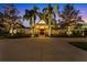 Elegant home exterior illuminated at night, showcasing curb appeal at 3709 Beneva Oaks Way, Sarasota, FL 34238