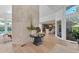 Bright foyer with marble accent wall, hardwood floors, and clear view to the formal dining room at 3709 Beneva Oaks Way, Sarasota, FL 34238