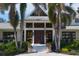 Elegant home exterior featuring lush landscaping, grand entrance, and symmetrical design, creating a welcoming curb appeal at 3709 Beneva Oaks Way, Sarasota, FL 34238