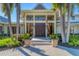 Elegant home exterior featuring lush landscaping, grand entrance, and symmetrical design, creating a welcoming curb appeal at 3709 Beneva Oaks Way, Sarasota, FL 34238