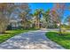 Landscaped front yard with circular driveway leading to a stunning home at 3709 Beneva Oaks Way, Sarasota, FL 34238