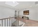 Bright hallway with natural light from a skylight, featuring modern railings and neutral decor at 3709 Beneva Oaks Way, Sarasota, FL 34238