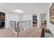 Bright upper hallway with skylight and views to bedrooms and office at 3709 Beneva Oaks Way, Sarasota, FL 34238