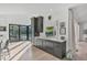 Dark gray kitchen island with white perimeter cabinets and a pool view at 3709 Beneva Oaks Way, Sarasota, FL 34238