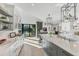 Modern kitchen with white and gray cabinetry, island, and access to the backyard at 3709 Beneva Oaks Way, Sarasota, FL 34238