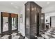 Laundry room with dark cabinetry and French doors at 3709 Beneva Oaks Way, Sarasota, FL 34238