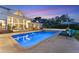 Tranquil night view of a sparkling pool and inviting patio area at 3709 Beneva Oaks Way, Sarasota, FL 34238