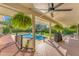 Relaxing pool deck with shaded seating and built-in grill, perfect for outdoor enjoyment at 3709 Beneva Oaks Way, Sarasota, FL 34238