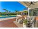 Gorgeous pool deck with ample seating and a view of the sparkling pool and lush landscaping at 3709 Beneva Oaks Way, Sarasota, FL 34238