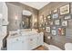 Stylish powder room with white vanity, gray wallpaper, and framed art at 3709 Beneva Oaks Way, Sarasota, FL 34238