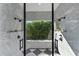 Spacious shower with marble walls, dual shower heads, and a view of lush greenery at 3709 Beneva Oaks Way, Sarasota, FL 34238