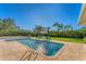 Inviting rectangular pool surrounded by a large patio and lush lawn at 3709 Beneva Oaks Way, Sarasota, FL 34238