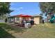 Backyard with patio, grill, and red umbrella at 372 Tihami Rd, Venice, FL 34293