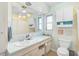 Clean bathroom with light teal vanity and a shower/tub combo at 372 Tihami Rd, Venice, FL 34293