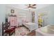 Charming bedroom with light pink accents and wood floors at 372 Tihami Rd, Venice, FL 34293