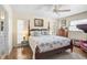 Spacious bedroom with wood floors and a post bed at 372 Tihami Rd, Venice, FL 34293