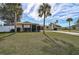 House with palm trees, a white fence, and a spacious yard at 372 Tihami Rd, Venice, FL 34293