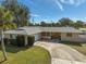 Single-story home with a large driveway and landscaped yard at 372 Tihami Rd, Venice, FL 34293