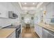 Bright kitchen with stainless steel appliances and light wood flooring at 372 Tihami Rd, Venice, FL 34293