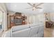 Living room with gray reclining sofas, and tiled floors at 372 Tihami Rd, Venice, FL 34293