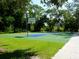 Outdoor basketball court featuring blue and green surface in a wooded park setting at 3822 Ironwood Ct, Sarasota, FL 34243