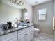 Clean bathroom featuring a granite countertop, white cabinets, and a modern toilet at 3822 Ironwood Ct, Sarasota, FL 34243