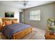 Comfortable bedroom featuring a wood frame bed, a ceiling fan and a window for natural light at 3822 Ironwood Ct, Sarasota, FL 34243