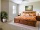 Cozy bedroom featuring a wooden bedframe, a ceiling fan and a window with blinds at 3822 Ironwood Ct, Sarasota, FL 34243