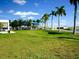 Expansive green space in a community area, perfect for recreation and relaxation, with palm trees and blue sky at 3822 Ironwood Ct, Sarasota, FL 34243