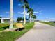 Inviting waterfront community scene, featuring walking paths, seating, and tropical landscaping under a clear blue sky at 3822 Ironwood Ct, Sarasota, FL 34243