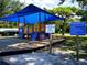 Tot Lot playground with play equipment and shade structure; playground rules sign visible at 3822 Ironwood Ct, Sarasota, FL 34243