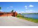 Waterfront view featuring a pathway, lush green shoreline, and the Nathan Benderson Park bridge at 3822 Ironwood Ct, Sarasota, FL 34243